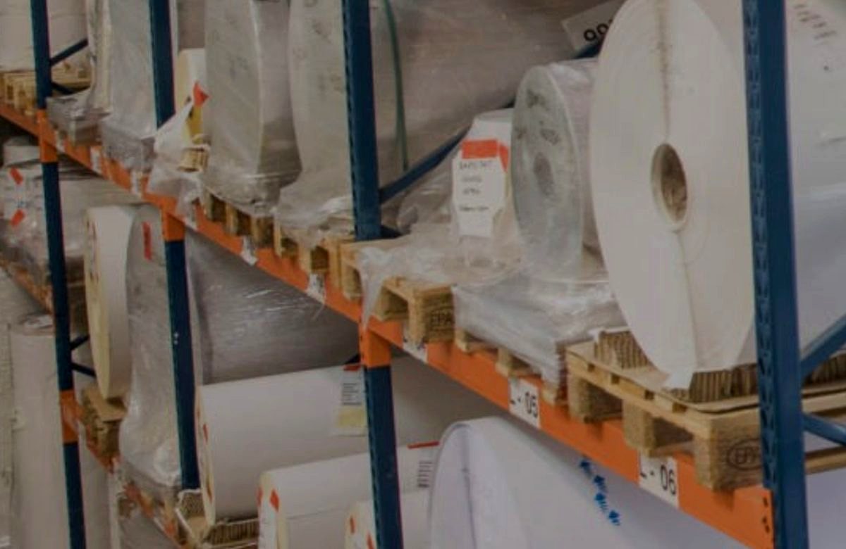 Master rolls of self-adhesive label material on racking at the Platinum Paper facility in Dublin